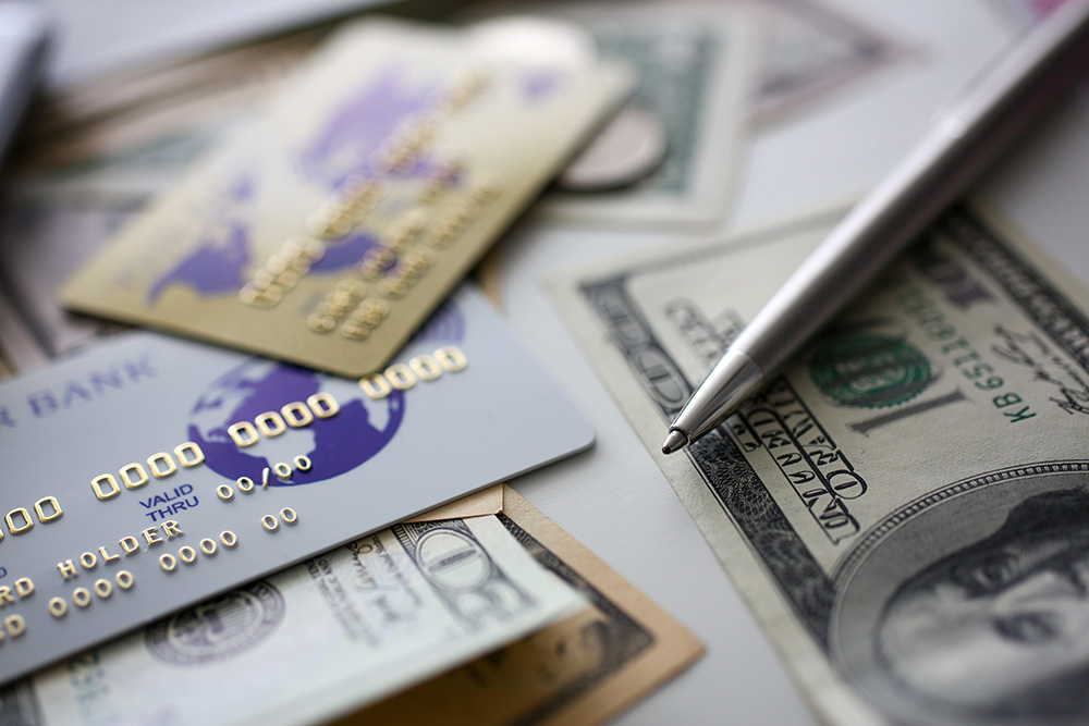 Credit cards, pen, and a dollar bill
