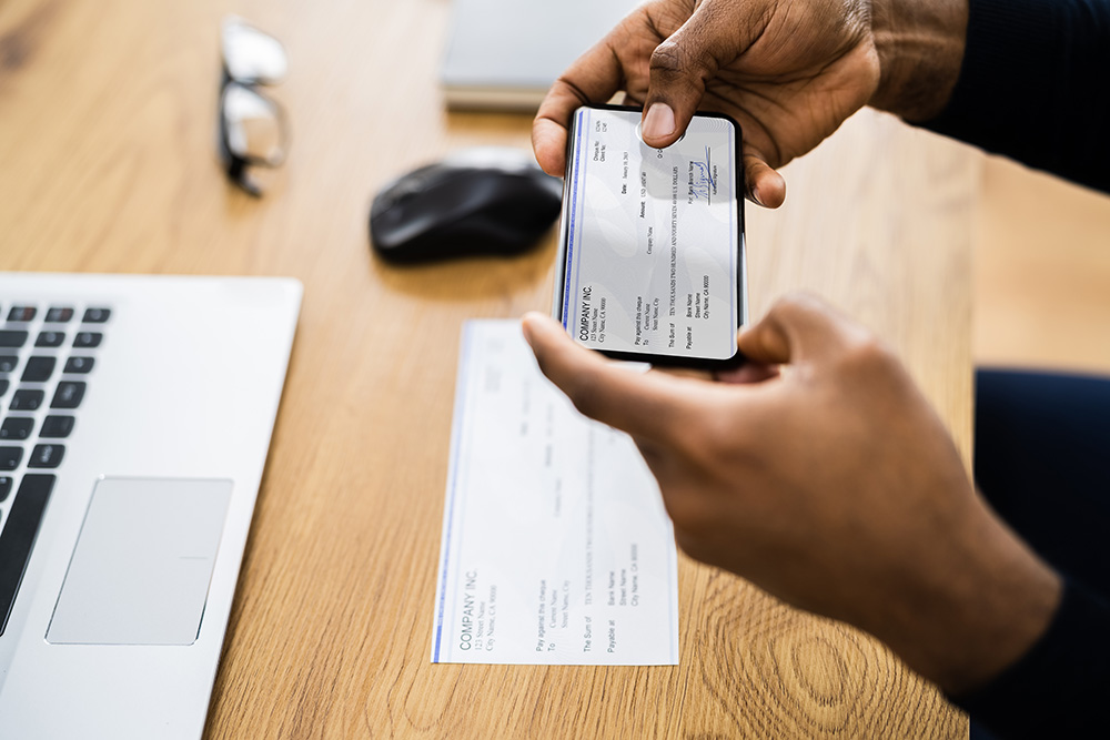 Man looking at cheque