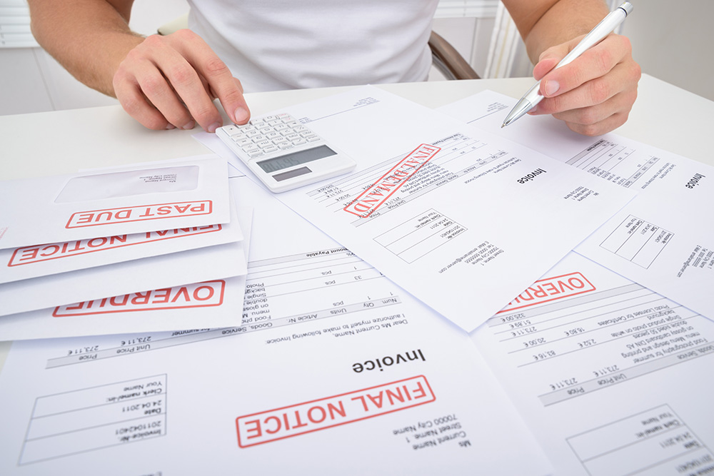 Man calculating overdue bills