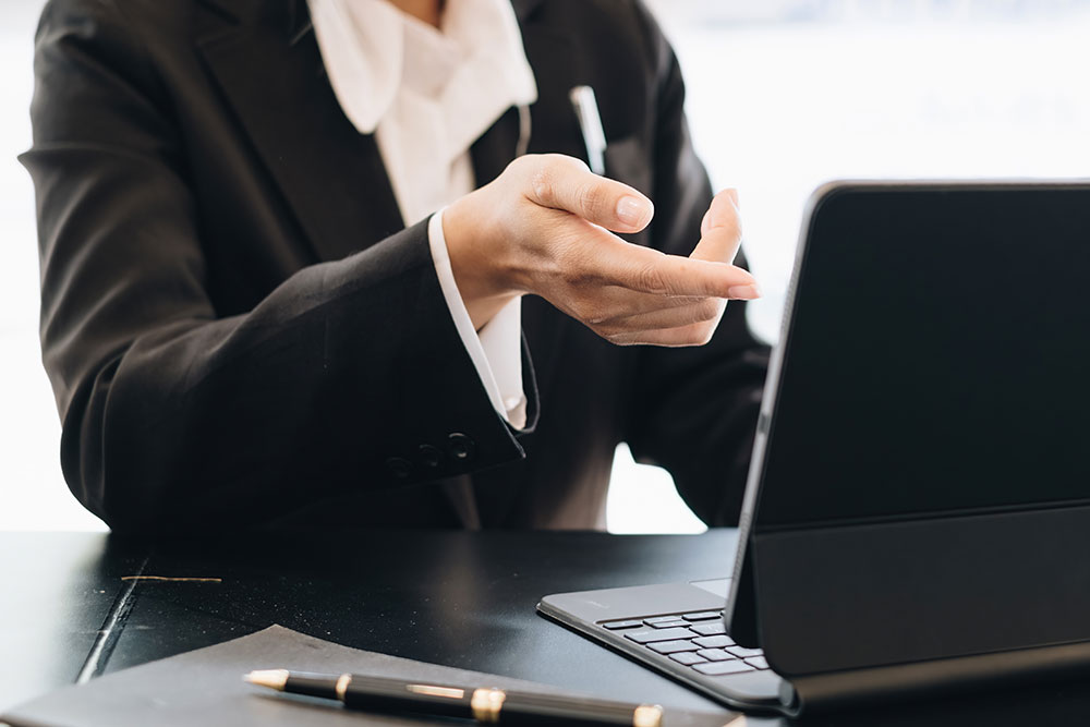 Collection attorney at her desk using a tablet