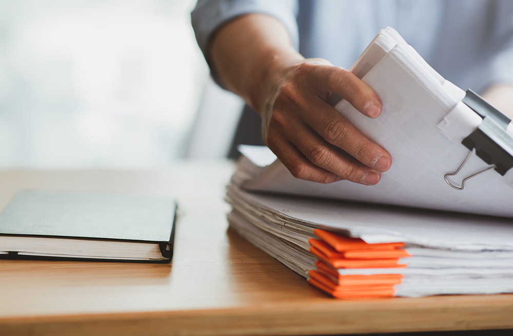 Man looking through paper files