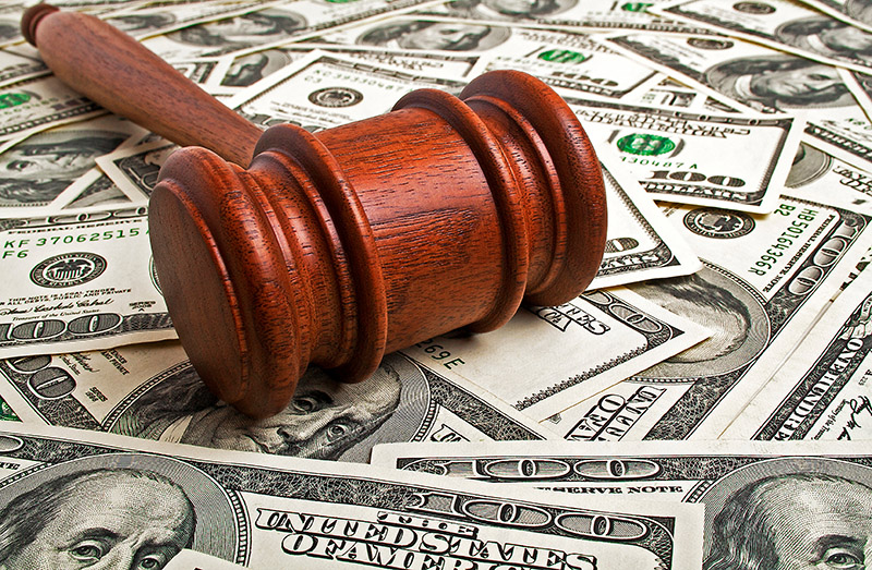 Wooden gavel and American dollars - Enforcing Your Judgment Graphic